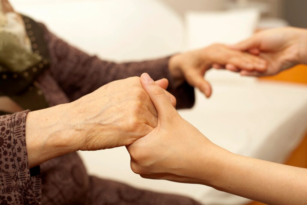 Two people holding hands in a room.